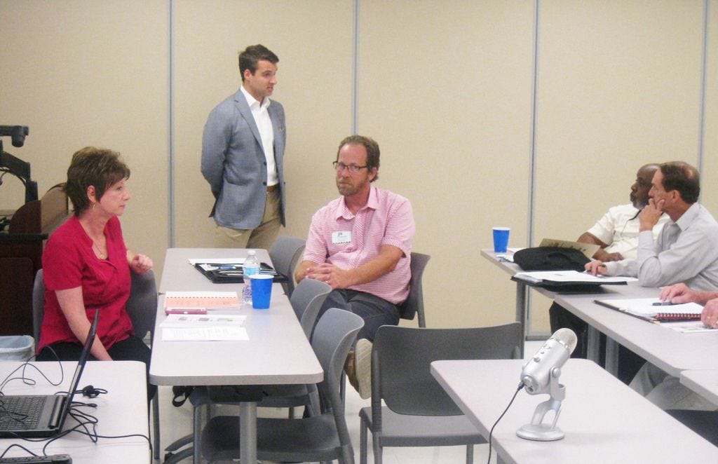 Matt Petro, chief development officer for Retail Strategies, standing, speaks during a June 24 Community Redevelopment Agency meeting. Seated from left are CRA Director Brenda Smith, Petermann Agency senior account executive Stephen Smith (no relation), and CRA board members Shannon Hayes and JB Whitten.