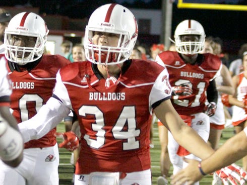 Matt French helps lead the Bulldogs onto the field.