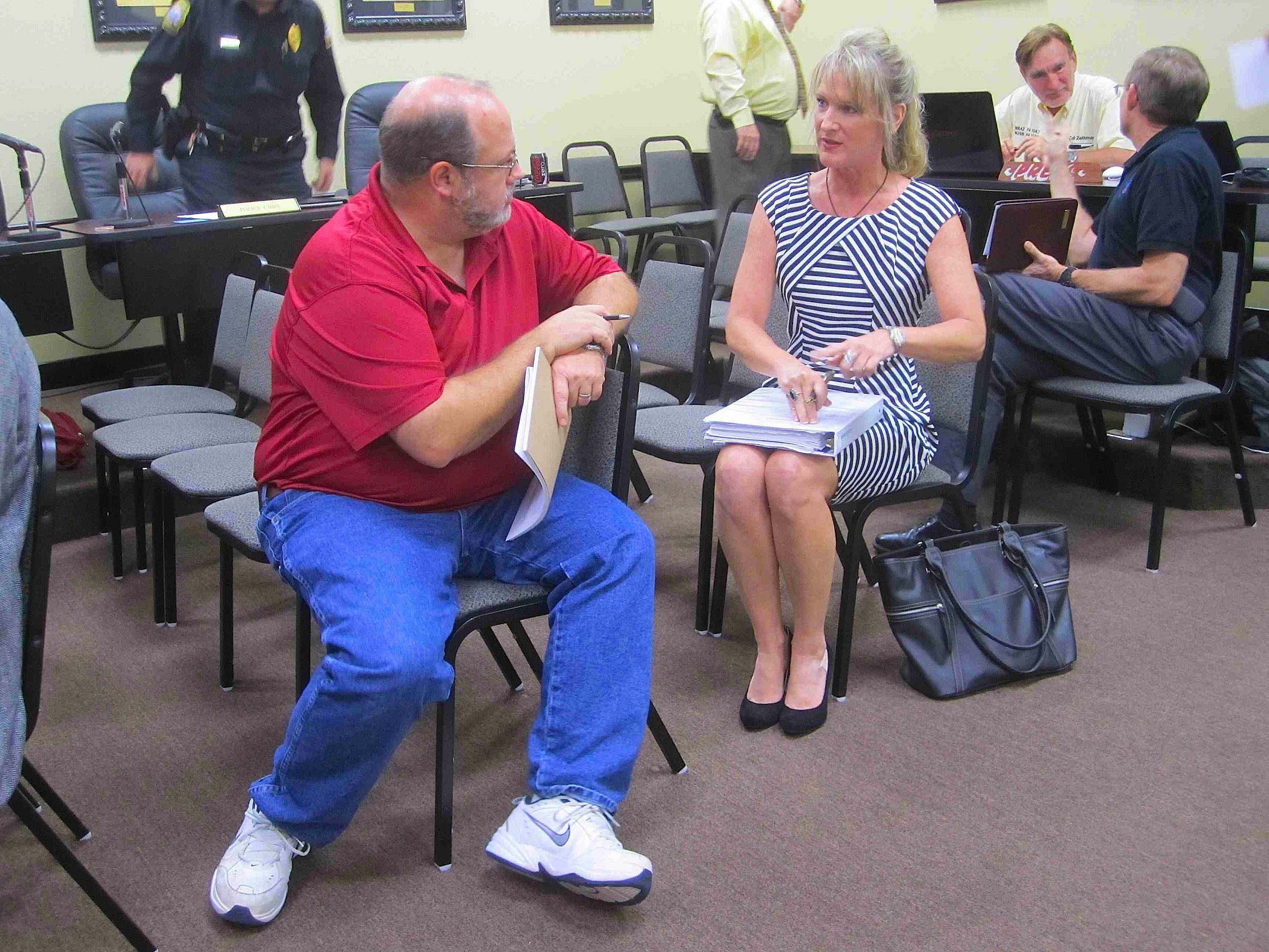 EDC interim President Kay Rasmussen chats with Crestview city planner Eric Davis prior to Monday evening's meeting of the city council. Rasmussen announced a major expansion of a Crestview Bob Sikes Airport tenant.