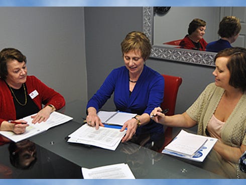 Crestview JobsPlus manager Rita Smith, University of Florida Okaloosa County Extension Office agent Elaine Courtney and IRS tax consultant Holly McCarroll discuss plans for an income tax assistance program starting Jan. 30. Volunteers will help moderate- to low-income taxpayers prepare their income tax returns.