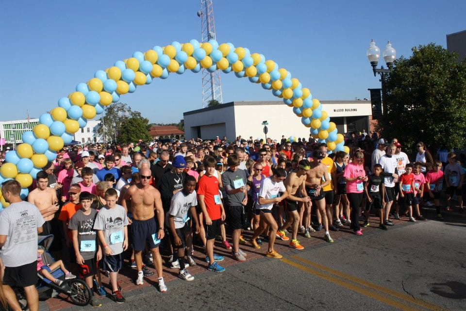 Runners prepare for the start of the October 2013 Race for Lace on Main Street. Mayor David Cadle has proposed establishing a fixed 5-kilometer race course to avoid disrupting traffic and businesses.