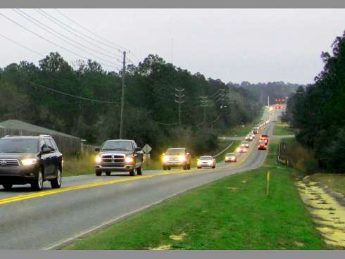 A stream of evening traffic flows west on P.J. Adams Parkway from State Road 85. Improvements slated to begin in 2015 will provide turn lanes to help relieve some of the congestion.