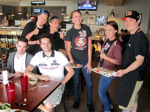 Steven Chevalier and Mathias Leroy, seated, receive a Crestview welcome from the staff at Bamboo Sushi Bar & Hibachi Express.