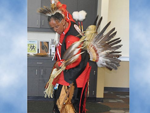 Kirby Locklear performas part of an Indian tribal dance he taught to attendees during a Tuesday presentation at Crestview Public Library.