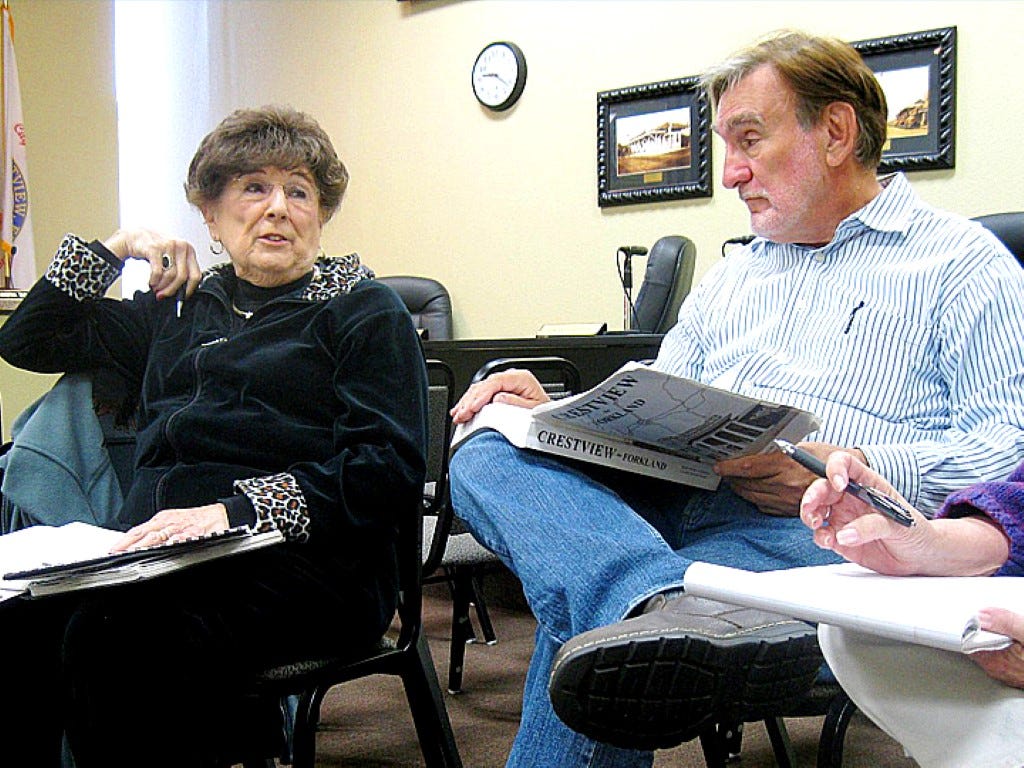 Crestview Centennial planning committee chairwoman Pat Hollarn discusses ideas for celebrating the city’s 100th birthday as Main Street Crestview Association member Cal Zethmayr refers to significant events using the area history book “Crestview: The Forkland" by Betty Curenton and Claudia Patten.