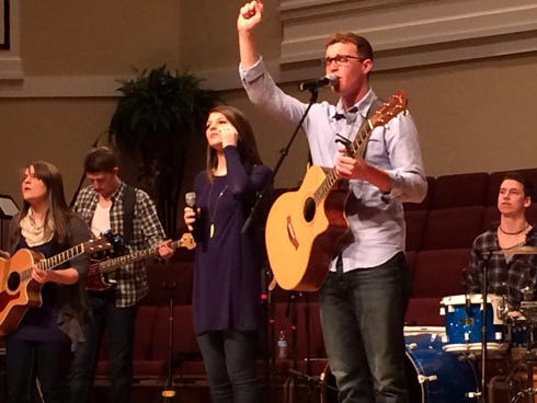 Crestview High School alumni Ryan Jackson, right, and Jessica Phillips, beside him, sing worship music with Impact, a mixed vocal ensemble from the University of Mobile. The group will minister on Monday at Emmanuel Baptist Church.