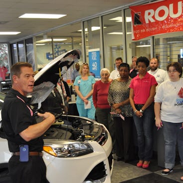 Hub City Ford consultant Brad Schaefer speaks to women about vehicle maintenance on Tuesday during "Heels and Wheels," a North Okaloosa Medical Center-Healthy Woman event.