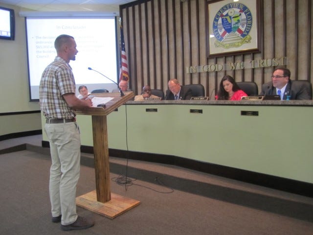 Crestview building official Jonathan Bilby addresses a question from city Councilman Thomas Gordon, right, during a workshop to consider permit fees.