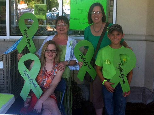 Connie Murray — left, with her daughter, Nikki, at a recent Lyme disease awareness event at Publix — and Connie B. — with her son, Bryson — will present a Lyme disease awareness documentary on Saturday in Crestview.